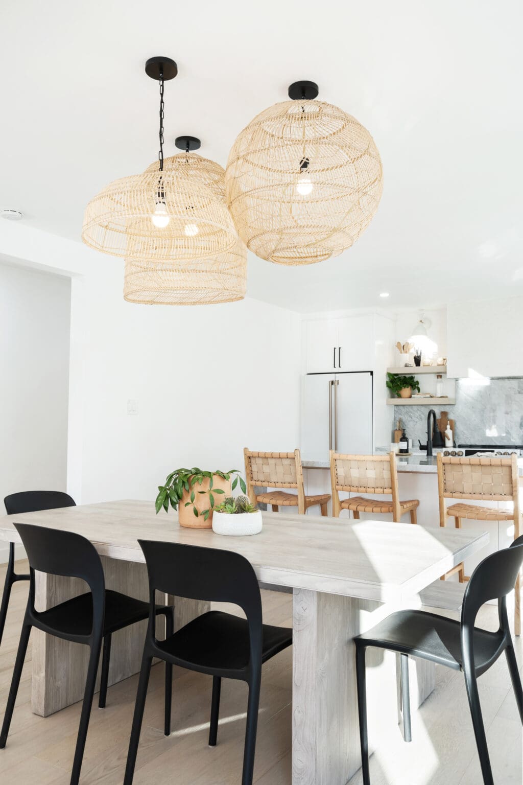 A dining room with a woven basket chandelier