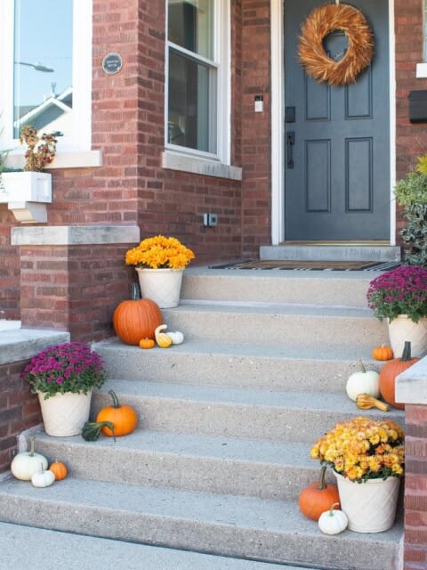 Our fall front porch with faux mums