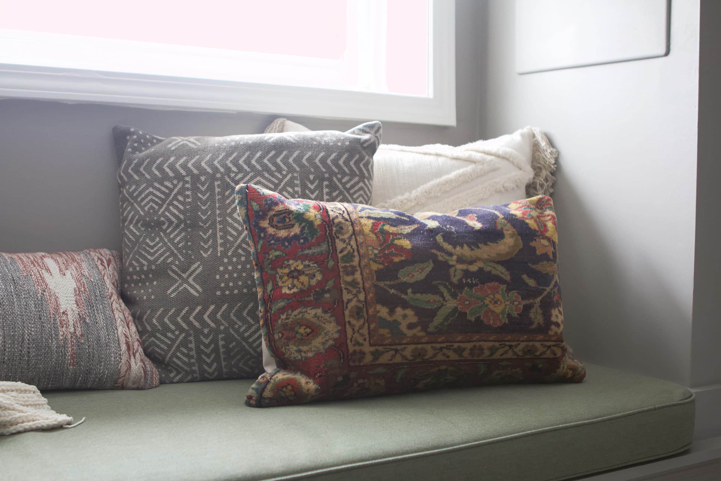Adding lots of pillows to our reading nook