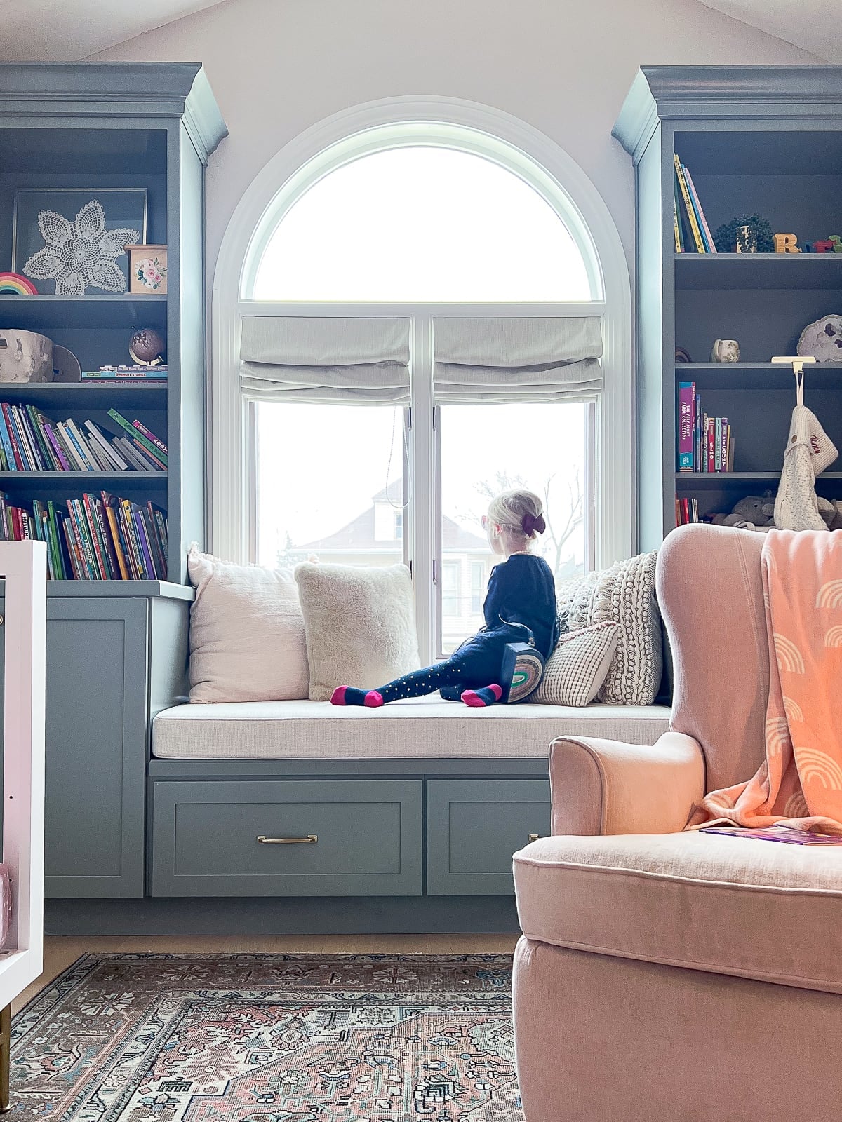 My daughter sitting at the window bench