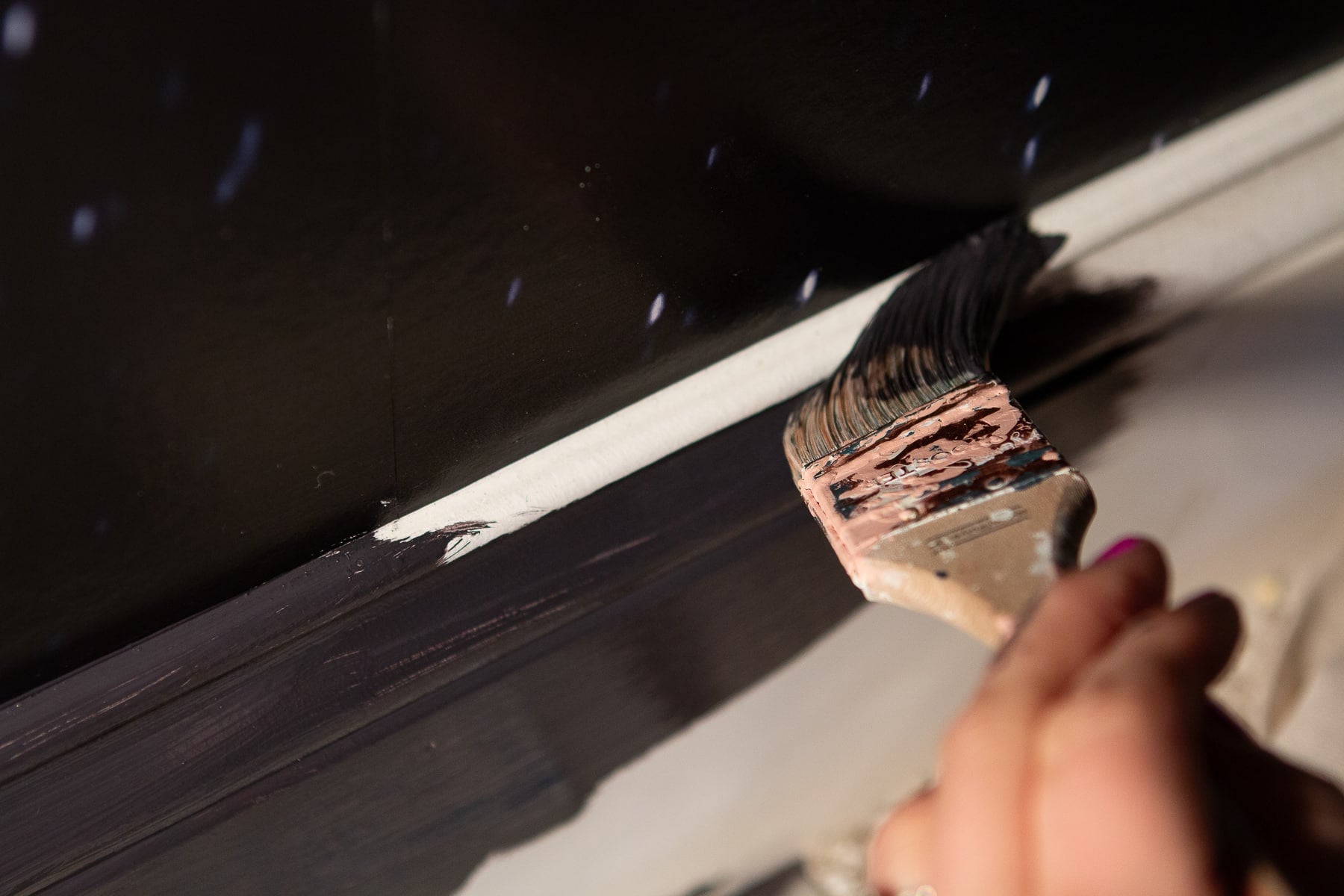 Cutting in a dark deep navy color next to wallpaper