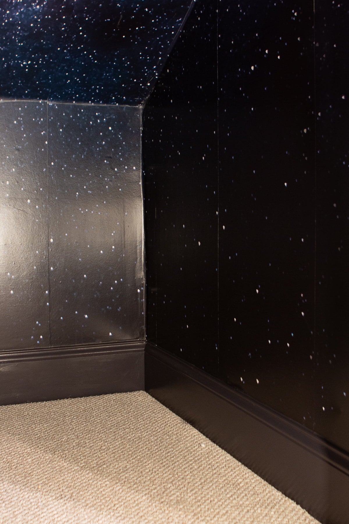 Dark blue paint in the basement closet with galaxy wallpaper