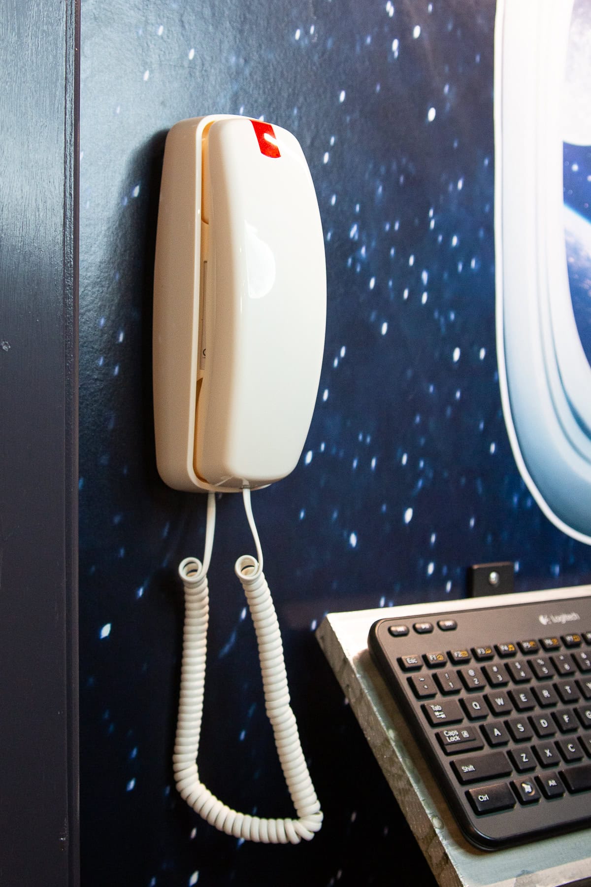 adding an old school phone to the wall of the space ship for the kids playroom