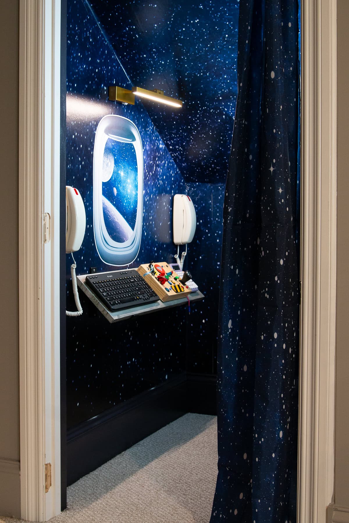 Adding a picture frame light over the mission control board in the spaceship closet