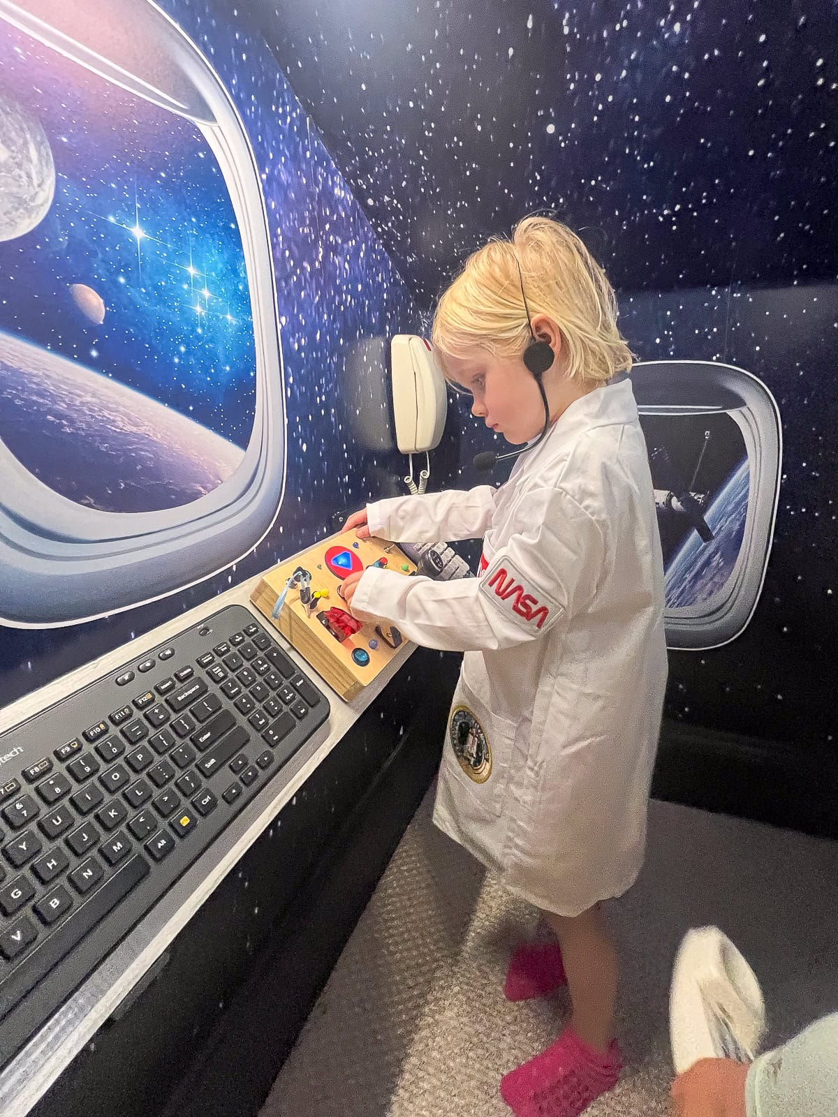 Rory with her lab coat on in the playroom