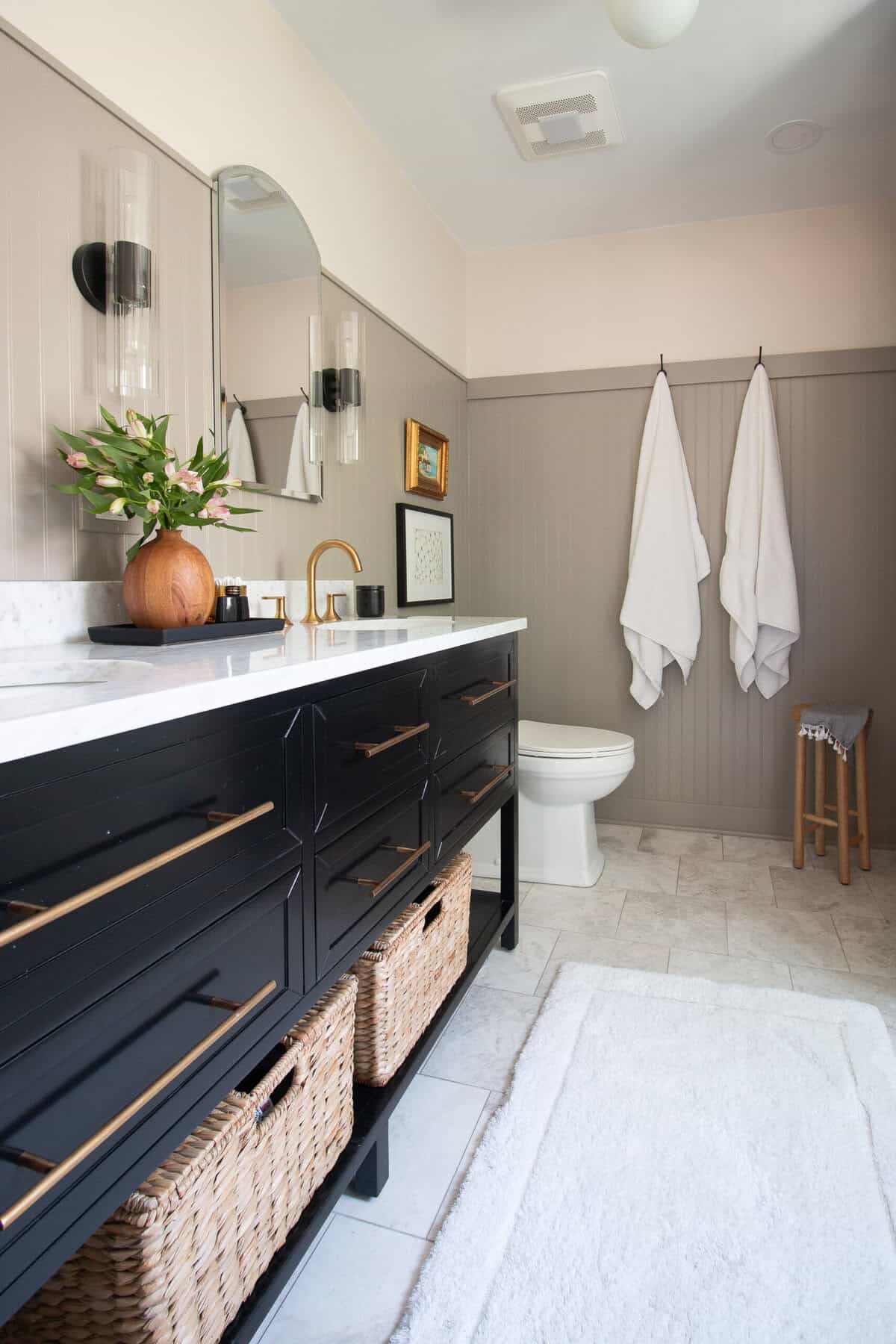 Bathroom with navy blue double sink vanity.