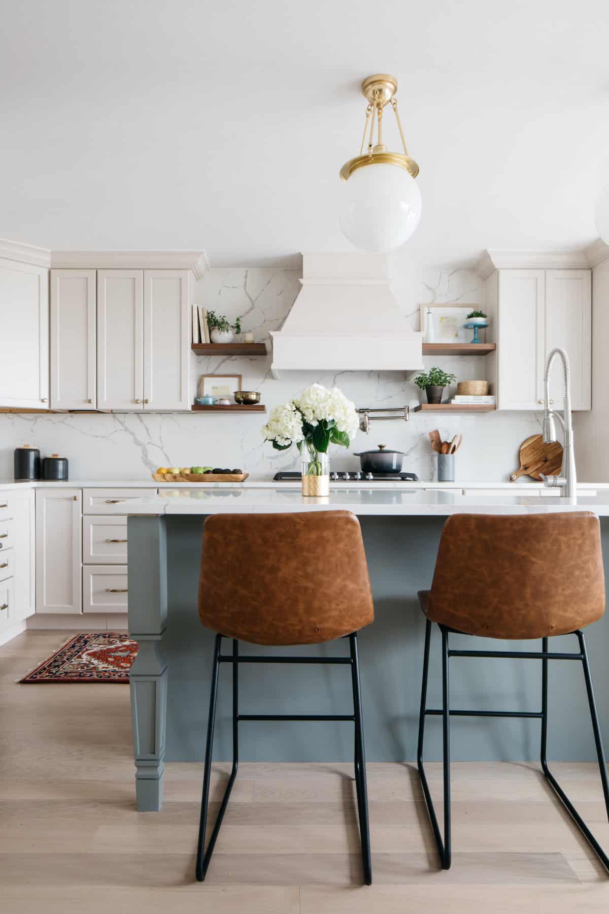 Our kitchen with leather barstools and brass pendants