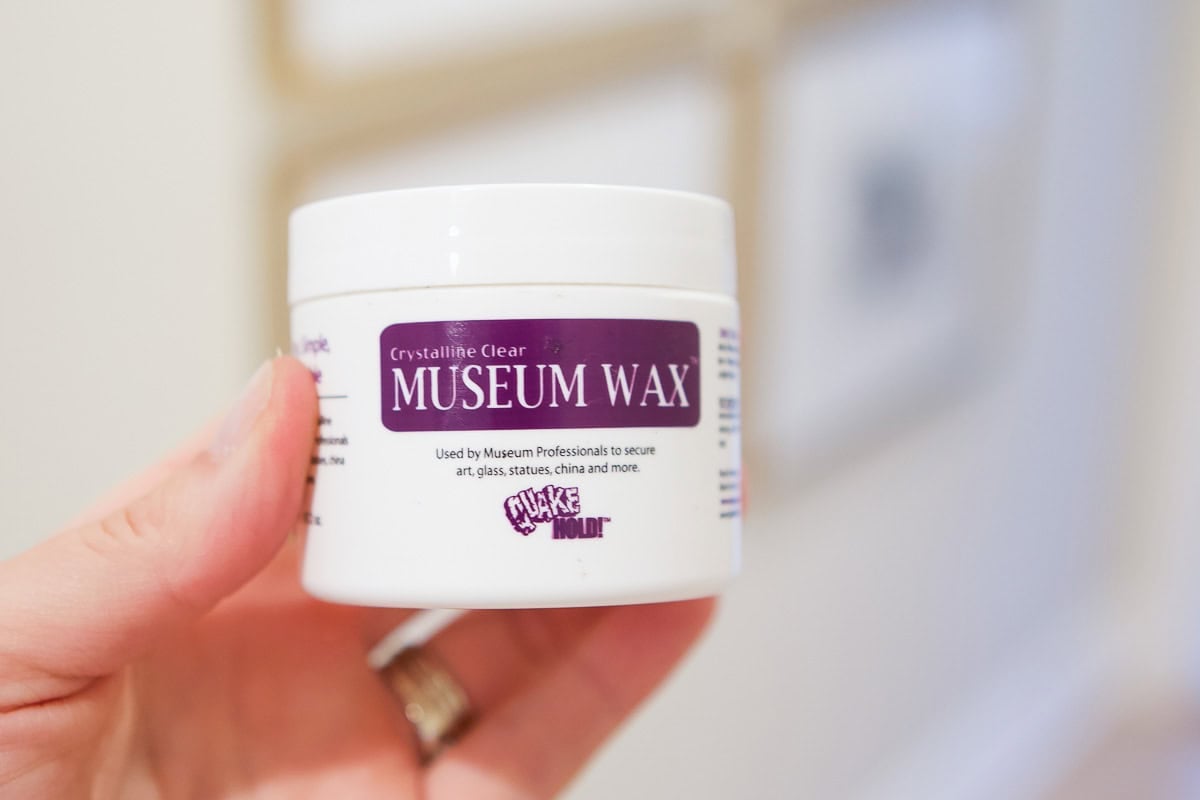 Museum wax can be used on the back of your frames to keep them in place