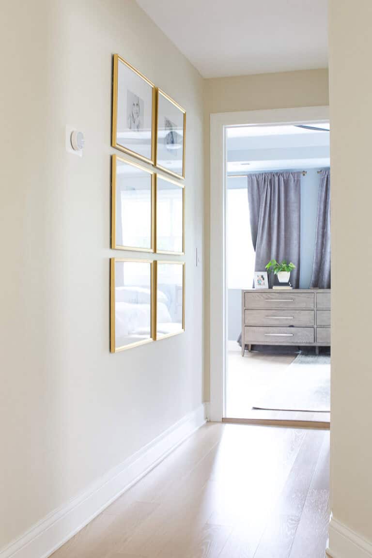 Adding a symmetrical gallery wall with gold frames to our upstairs hallway