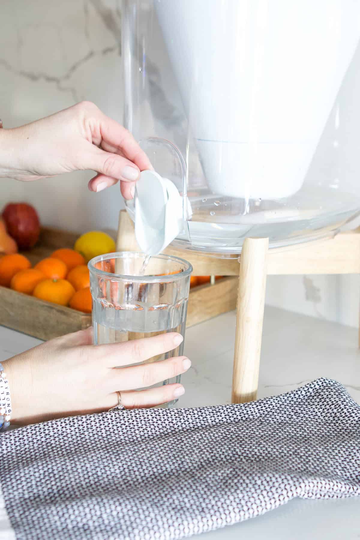 Filling up a glass of water from a filtered dispenser