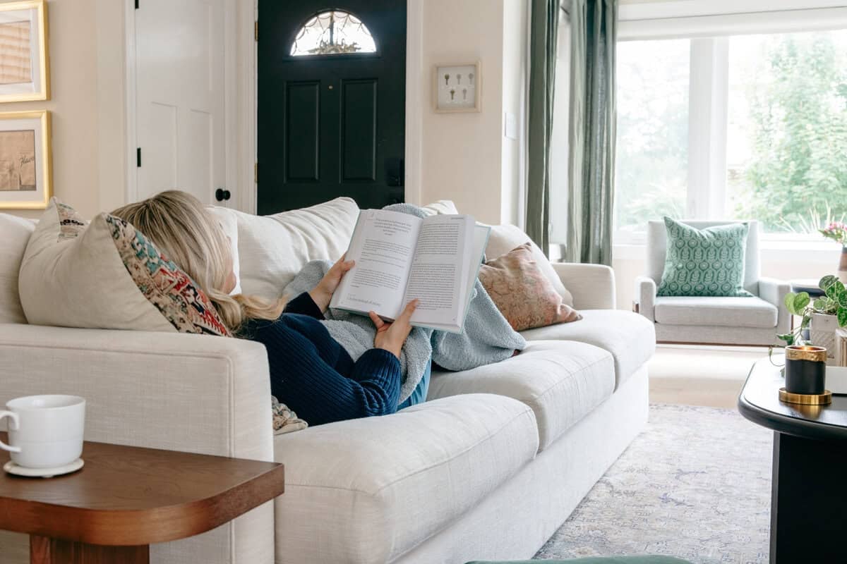 Bright and layered living room with soft textures, neutral tones, and cozy Nancy Meyers aesthetic details.