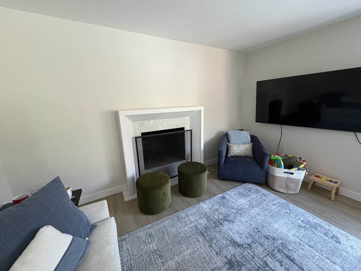 a simple fireplace mantel and television in a living room
