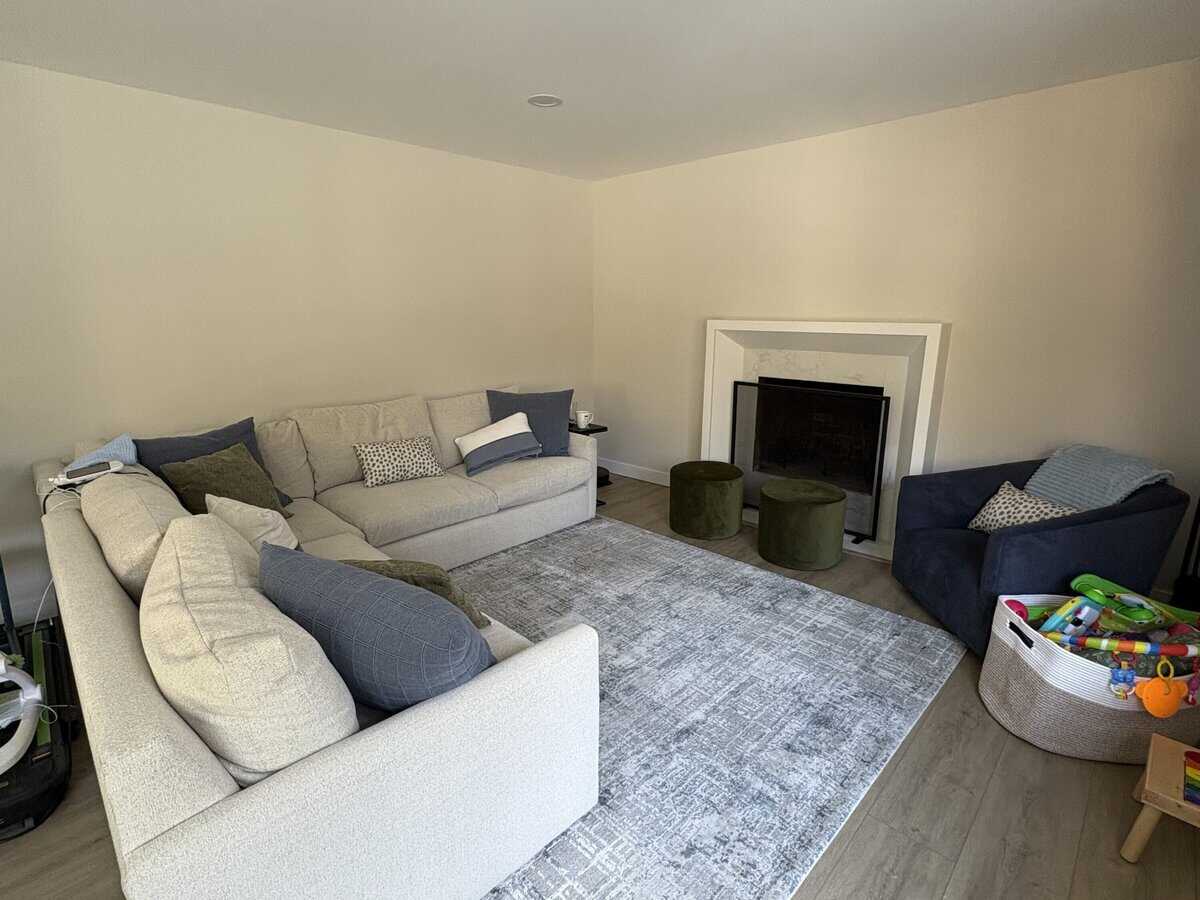 plain mantel in a living room with a sectional